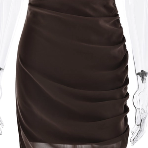 Detailed close-up of dark brown chiffon dress showing waist ruffles and pleated textures