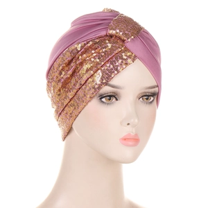 Detail of pink-purple turban hat with shimmering gold sequins for women in macro view