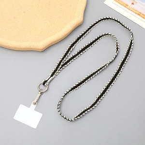 Braided crossbody phone lanyard in black and gold weave with silver metal clasp
