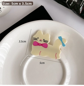 Close-up of cat hair clip measuring 5cm by 3.5cm with pink and blue ribbon bows