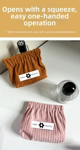 Detail of corduroy makeup bag with spring closure for lipstick and small accessories