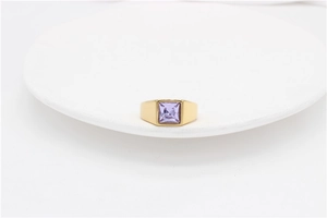 Macro shot of gold-plated titanium ring featuring a square-cut lavender gemstone on white
