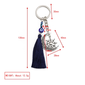 Detailed view of bohemian evil eye keychain with blue tassel and moon charm measurements