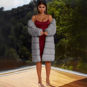 Elegant long-sleeved gray faux fur coat for women styled over a red satin dress