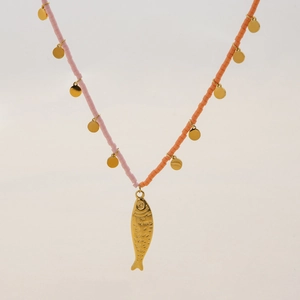 Pink and orange beaded necklace with gold fish pendant and discs on white background