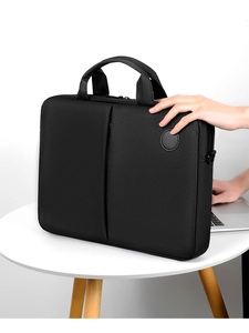 Detailed view of the black nylon laptop bag material with hand showing texture and size