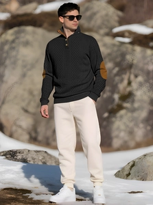 Detail of dark grey knit sweater with brown elbow patches and buttoned stand collar