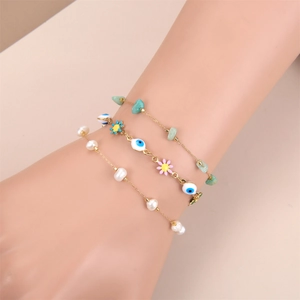 Three-piece gold chain bracelet set with evil eye charm, turquoise stones, and pearls