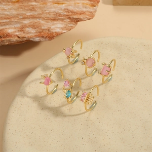 Set of six gold plated adjustable rings with zircon hearts and cat eye stones