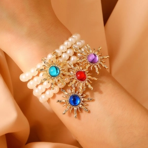 Vintage sunburst gold bracelets set with faux pearls and colorful gemstones for women