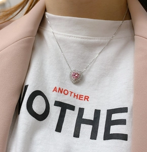 Detail of s925 silver necklace featuring a double-layered heart-shaped pink stone pendant