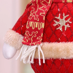 Macro detail of knit texture and sparkling sequin fabric on Christmas plush toy