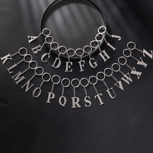 Polished stainless steel keychains with all 26 uppercase letters A-Z on a black surface