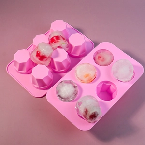 Detailed view of pink 6-cavity diamond silicone mold with fruit-filled ice cubes