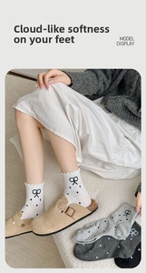 Detail of polka dot crew socks with bow embroidery and scalloped edges for women