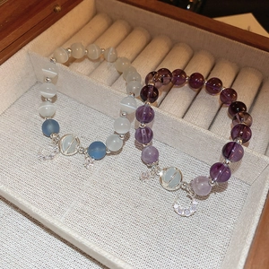 Vintage cat-eye bead bracelets with moon and star zircon pendants on warm jewelry box base