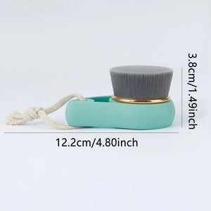 Bamboo charcoal facial cleansing brush with mint green handle and golden ring detail