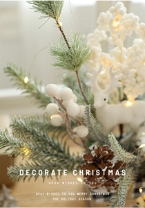 Macro shot of festive Christmas arrangement with pine cones and white reindeer figurine