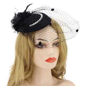 Detail of black fascinator hat with elegant veil, feathers, and white pearl embellishments