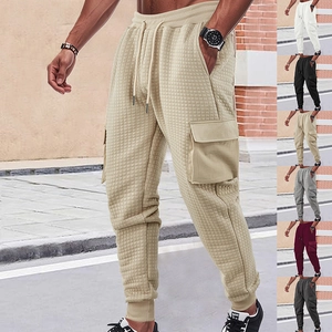 Detail of waffle knit men's joggers showing khaki, white, black, grey and burgundy colors