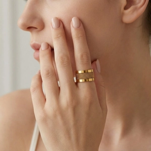 Detailed view of wide gold mesh ring on model showcasing trendy punk style