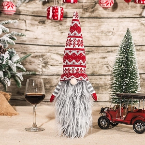 Close-up of Christmas gnome wine bottle cover with red knit hat and long beard detail