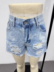 Slim fit ripped denim shorts for women featuring distressed fringe and high waist in light blue