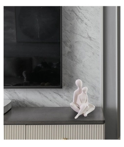 Close-up of minimalist white ceramic hug sculpture on dark wooden modern furniture