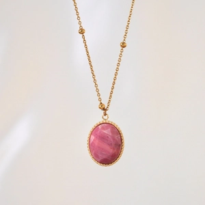 Detailed view of pink faceted stone pendant with 14K gold beaded stainless steel chain