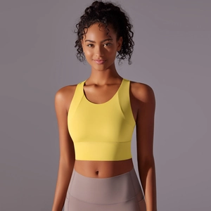 Detail view of the seamless moisture-wicking fabric on the yellow yoga sports bra