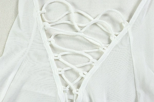 Détail de robe blanche en maille avec laçage croisé et texture en résille fine
