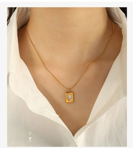 Detailed shot of an 18K gold-plated emerald necklace with a pear-cut zircon pendant