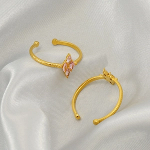Adjustable gold plated stainless steel ring with pink marquise zircon stones and hammered texture