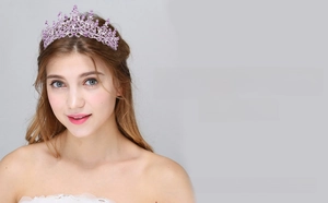 Detailed view of a purple crystal crown with silver metal frame and pear-shaped rhinestone