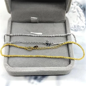 Detail showing S925 sterling silver sparkled chains in gold and silver within a gift box