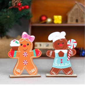 Detail of wooden gingerbread man and girl figurines with festive hats and aprons