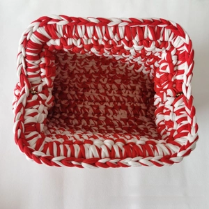 Detail view of the red and white handmade crochet bag with thick woven texture