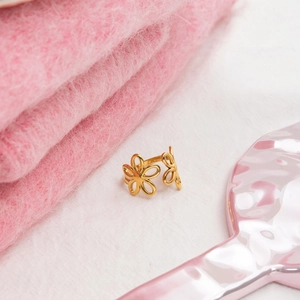 Detail of 18K gold stainless steel open ring with intricate hollow flower petal design