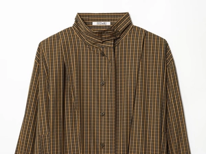 Detail of high stand collar and brown plaid pattern on a cotton blend long sleeve shirt