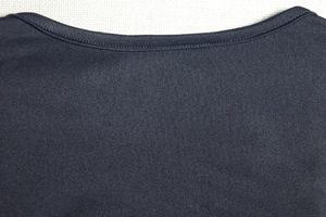 Detail view of the fine knit neckline and double-needle stitching on the navy dress
