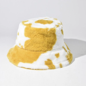 Close-up of yellow cow print faux fur bucket hat showing thick plush texture and soft fabric