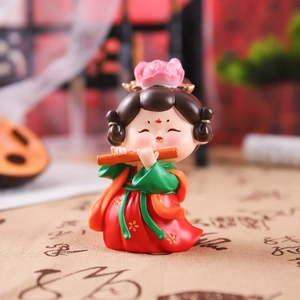 Traditional Chinese lady figurine playing bamboo flute in elegant red and green hanfu attire
