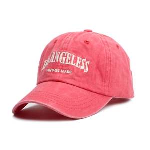 Close-up of vintage coral pink washed cotton baseball cap with white 3D embroidery detail