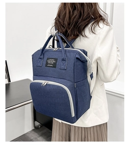 Detail of waterproof Oxford fabric and stitching on the dark blue backpack for moms