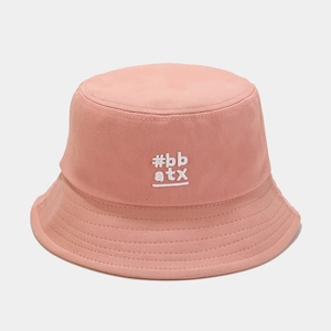 Close-up of pink cotton bucket hat with white #bb atx embroidery and stitched brim