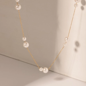 Elegant 18k gold stainless steel necklace featuring mixed white pearl accents