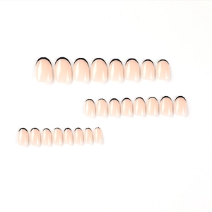 Short oval press-on nails with nude pink base and minimalist black French tips