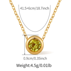 Macro detail of 18K gold-plated heart pendant with yellow round-cut gemstone and dimensions