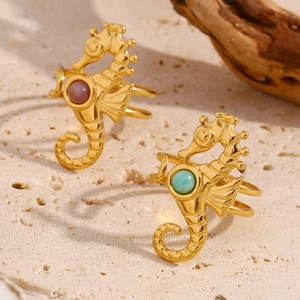 18K gold plated seahorse open ring with purple and turquoise gemstones on stone background