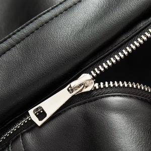 Detail view of premium black faux leather texture with high-quality silver metal zipper